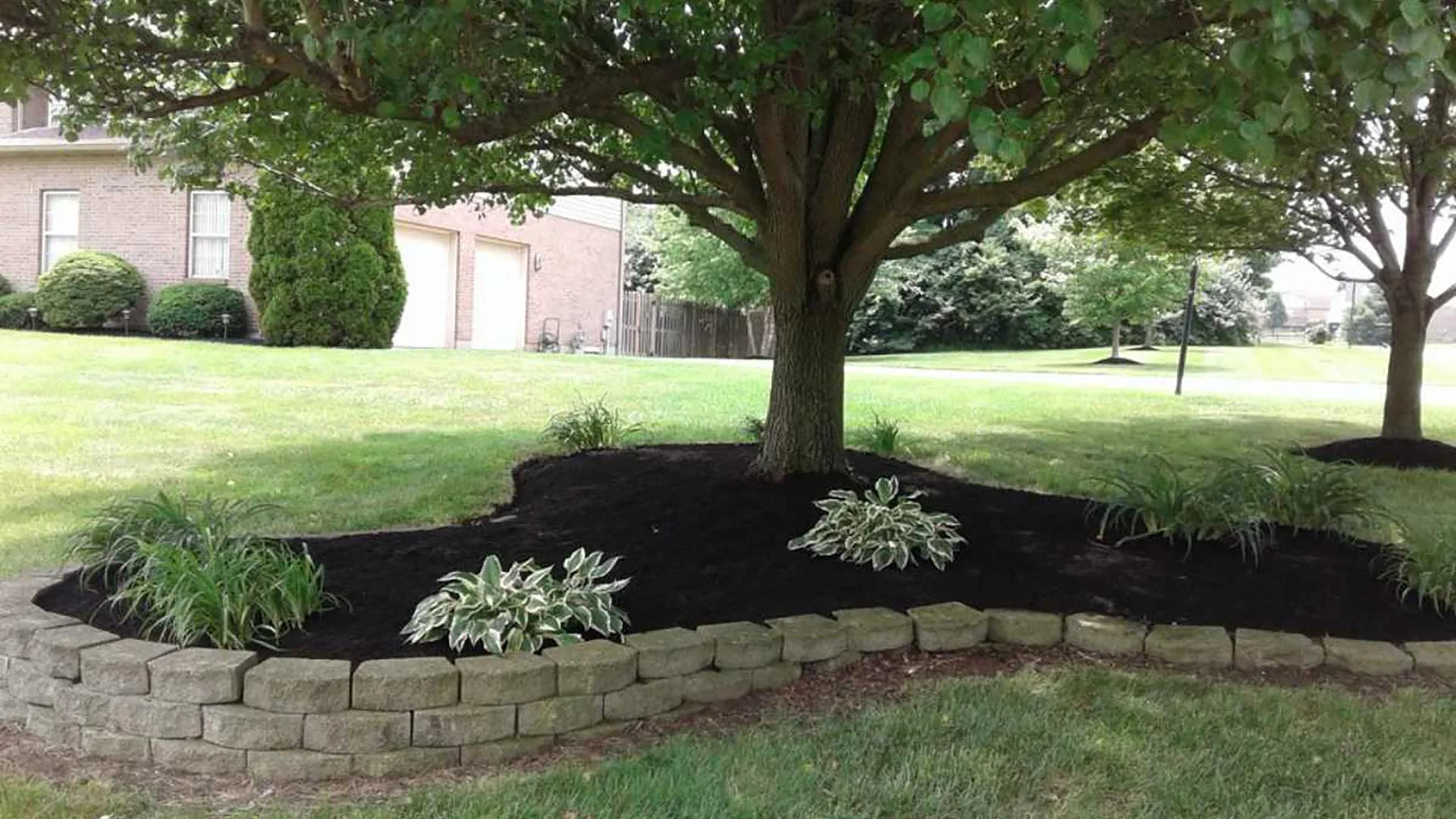 Landscape bed with retaining wall built in Mason, OH.