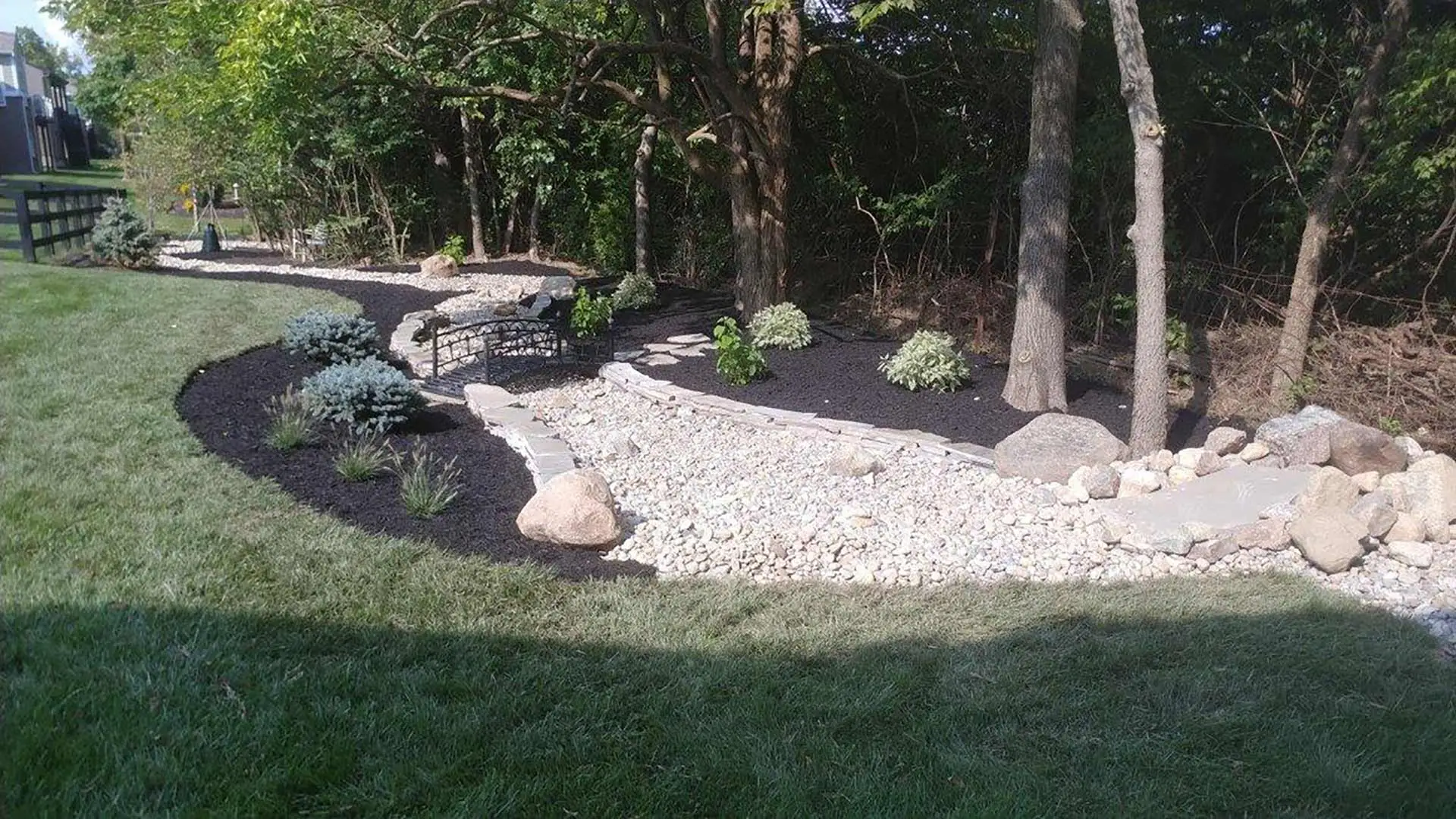 Rocks, mulch, and platnings installed for landscape in West Chester Township, OH.