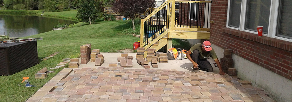Professional installing pavers for a patio installation in Liberty Township, OH.