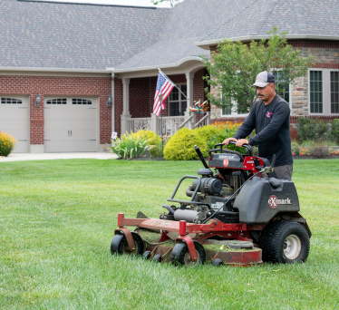 Guy mowing grass